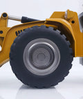 Side view of a Powerful 1 To 14 Scale RC Wheel Loader With 2 Point 4G Remote, showing alloy wheel and part of metal cab structure.