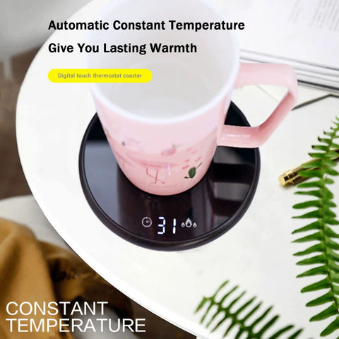 Electric Mug Warmer With Adjustable Temperature And Smart Touch Control on a bedside table with a pink mug.
