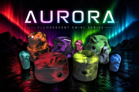Colorful resin guitar knobs from Aurora Fluorescent Swirl Series under vibrant lights, showcasing unique designs and colors.