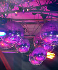 1.5 RPM Slow Disco Ball Motor for 4 to 16 Inch Mirror Balls reflecting lights at a party, showing smooth 360 degree rotation