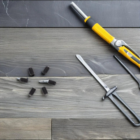 Rock Solid Spring Loaded Ball Plunger Set Screws M4x6 Hex Socket Cup Points 50 Pack with tools on wooden surface.