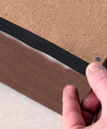 Heavy Duty Black Rubber Upholstery Tack Strip 11 Yard Roll 0.6 Inch Wide Furniture Edge Trim attached to chair edge