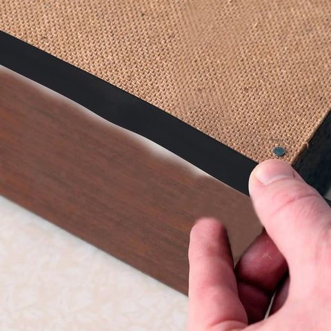 Heavy Duty Black Rubber Upholstery Tack Strip 11 Yard Roll 0.6 Inch Wide Furniture Edge Trim attached to chair edge