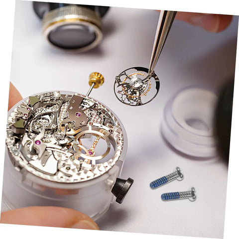 Close-up of 100Pcs Eyeglass Repair Screws Kit For Quick Eyewear Fixes with tools and intricate watch mechanism in view