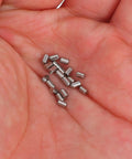 Hand holding stainless steel ball catch springs for closet doors and cabinets, smooth no snag operation, 20 pack for home DIY