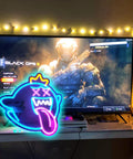 Totally Lit Ghost Neon Sign LED Light with dimmable switch and colorful rainbow glow next to gaming setup, USB powered, easy mount.