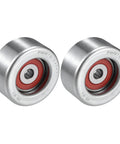 Two metal drive belt idler pulleys with red seals, front view