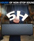 Person holding 40W Desktop Amp For Acoustic Electric Bass And Mic With 52 Amp Models And 49 FX for portability.