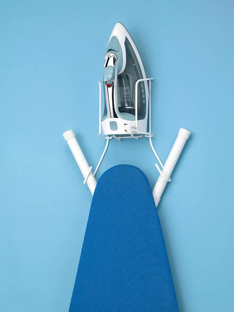 Wire Over The Door Ironing Caddy For Iron And Ironing Board Storage Organizer White mounted on blue wall with iron and board