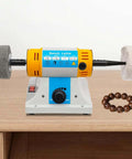 Pro Grade Bench Top Polisher And Grinder For Sanding Grinding And Polishing With 320W Motor And Variable Speed 800 To 10000 RPM 110V Yellow Industrial Tool Includes A Full Accessory Kit For Workshops Makers And DIYers on a wooden workbench.