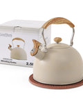 Stove Top 2.5 Quart Whistling Tea Kettle With Food Grade 18 8 Stainless Steel Wood Pattern Folding Handle Creamy White Finish Fast Heating Easy Clean Includes Silicone Heat Insulation Pad next to product box.