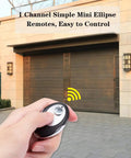 Hand holding Four Pack Yellow Learn Button Garage Door Remote Keychain Replacements For Sears Craftsman Chamberlain And LiftMaster Models 891LM 893LM 950ESTD 953ESTD No Fuss Plug And Play in front of garage door