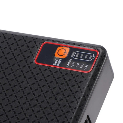 Compact Mini Ups Router Modem Backup Power With 15600 Mah Battery showing power indicator and textured surface.