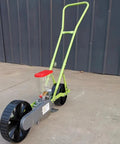 Compact Manual Garden Seed Spreader Workhorse And Planter Tool For One Row Seed Distribution handheld seeder on wheels