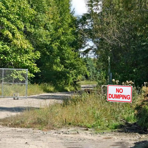 Heavy Duty Aluminum No Dumping Signs Two Pack Shut Down Illegal Dumpers Keep Yard Shipshape UV Blocked sign near a dirt path.