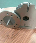 12 Inch Precision Rotary Table Featuring Killer Accuracy 10 Inch 3 Jaw Chuck Reversible Jaws Index Plates Smooth Operation Shop Ready side view on wood