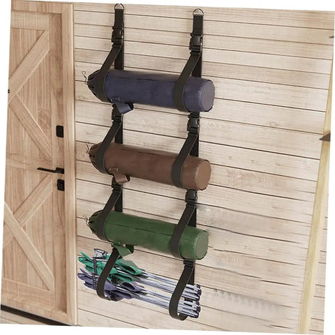 Heavy Duty Adjustable Wall Storage Straps With Badass Rugged Buckles Perfect For Camping Chairs Yoga Mats And Tents, holding three rolled items.