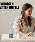 Portable Hydrogen Water Bottle With 1400ppb Generator beside woman at desk, 460ml Hydration Cup visible