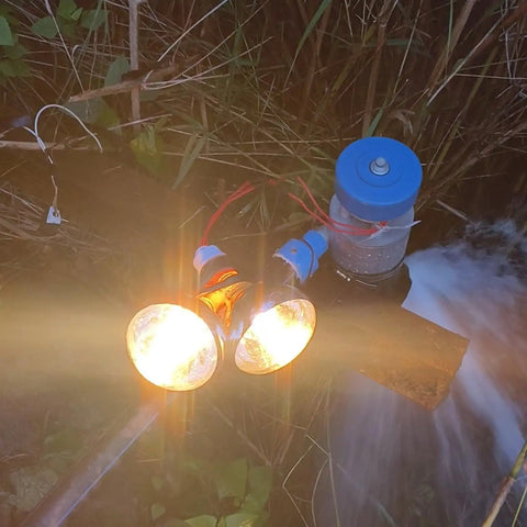 Beast 500W Micro Hydroelectric Turbine powering lights outdoors, water flowing through turbine, for off-grid lighting