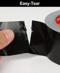 Black Duct Tape Heavy Duty Roll 5 Inch By 55 Yards Industrial Strength Waterproof Tape With 9.1 Mil Thickness, Flexible No Residue, UV Resistant For Outdoor Repairs Tear By Hand, Built For Quick Fixes. Easy-tear black duct tape being torn by hand from a roll