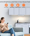 Woman using phone to control Stick Anywhere Closet Light Kit With Motion Sensor 6 Pack 30 LED Dimmer Under Cabinet Lights