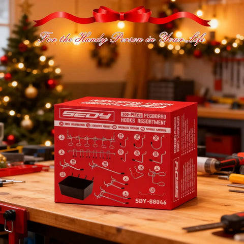 Box of 300 Piece Pegboard Hook Set For Garage And Workshop Organization on a workshop table with tools and holiday decorations.