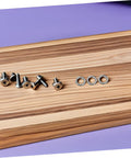 Heavy Duty Stainless Steel Split Lock Washers 100 Piece Assortment Kit For Nuts And Bolts Built Tough With Zero Slack Vibration Control For No Sweat Auto Repair And Everyday Hardware Jobs on a wooden surface with screws.