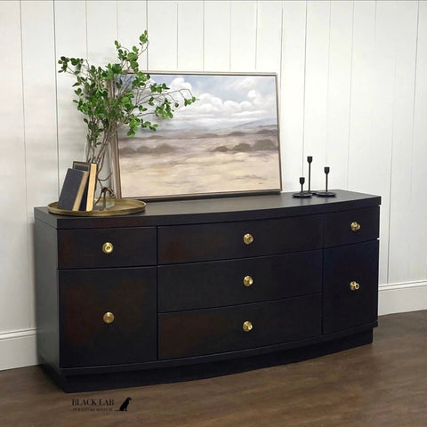Sideboard painted with Chalk Mineral Furniture Paint Matte Black Caviar 16oz, featuring gold knobs and decor in a room setting.