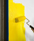 Heavy-Duty 9 Inch Microfiber Woven Paint Roller Covers With A Snug 3/4 Inch Nap painting a yellow wall indoors.