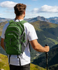 Hiker with 20L Lightweight Hiking Backpack Waterproof Daypack For Camping Ergonomic Back Panel in mountain landscape