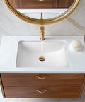 Overhead view of undermount white rectangular ceramic bathroom sink with overflow and durable glazed finish installed in wooden vanity.