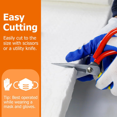Close-up of gloved hands cutting a white ceramic fiber insulation blanket with red-handled scissors.