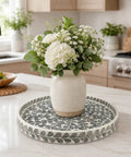 Game Changing 12.5 Inch Wooden Lazy Susan Turntable With A Smooth Swivel Base Sharp Black Leaf Design And Authentic Mother Of Pearl Inlay showcasing a vase with flowers.