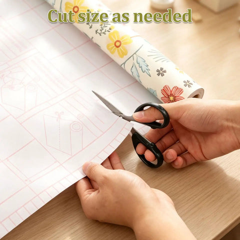 Self Adhesive Floral Peel And Stick Wallpaper Roll For Renters Featuring No Fuss Quick Install Water Resistant Scratch Proof Vinyl Wall Covering being cut with scissors.