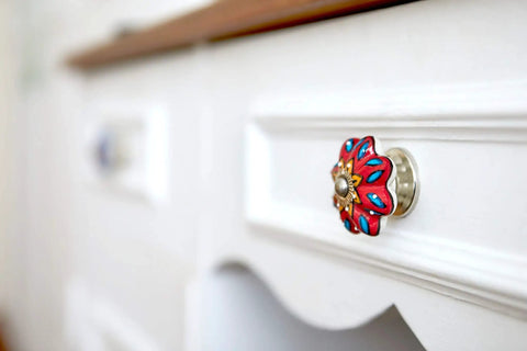 Close-up of red flower ceramic knob on white drawer from Handmade Flower Ceramic Knob Set of 10 with Colorful Multi Design Cabinet Knobs