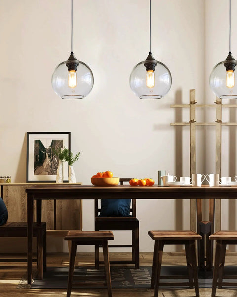 Globe Pendant Lights Set of 3 Hand Blown Glass With Clear Seeded Bubbles over dining table, modern rustic kitchen lighting.