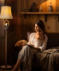 Cozy Farmhouse Vibe Antlers Floor Lamp With Night Light beside woman reading on sofa, faux leather bell shade, rustic setting.