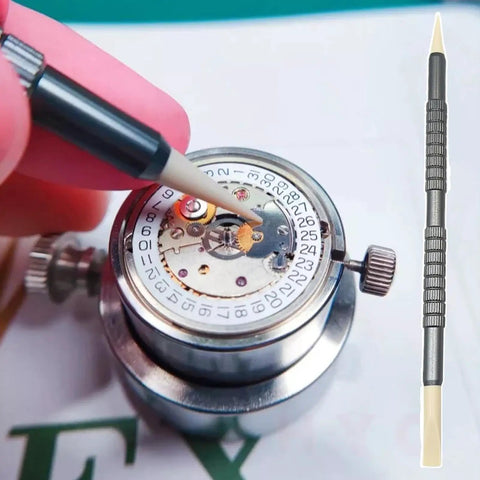 Precision Watch Cleaning Pen With Double Head Rubber Tips For Dials, Case Gaps, And Gear Clearance in use on watch mechanism.