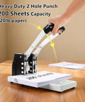 Heavy Duty Two Hole Punch Boasting A Sure Grip And Rugged Steel Body That Blows Through Two Hundred Sheets With No Sweat For Fast Office Jobs School Essays And Snappy Binder Prep In Clean White, in use, punching 200 sheets of paper.
