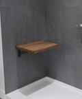 Wall Mount Foldable Teak Shower Bench 17 By 12.6 Inch Teakwood Bath Seat in bathroom, mounted on gray wall, folded out.