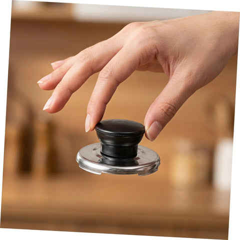 Upgrade Your Whistling Kettle With This Stainless Steel Knob Replacement Kit That Offers An Easy Install, Comfortable Grip, And Durable Build To Protect Your Lid Handle While Keeping Kitchen Swag Super Fresh. Black stainless steel kettle lid knob replacement kit shown in hand