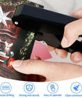 Close-up of a hand using a Heavy-Duty Oval Hole Punch, Metal Handheld Slot Puncher For ID Cards And Paper on colorful card.