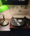 Green Glass Bankers Desk Lamp With Pull Chain Switch Plug In Fixture E26 Socket Max 60 Watt Bulb Compatible Adjustable Reading Light For Office Home Great For Reading And Tasks No Fuss next to a turntable on a dark wood table.