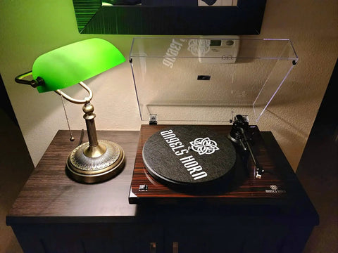 Green Glass Bankers Desk Lamp With Pull Chain Switch Plug In Fixture E26 Socket Max 60 Watt Bulb Compatible Adjustable Reading Light For Office Home Great For Reading And Tasks No Fuss next to a turntable on a dark wood table.
