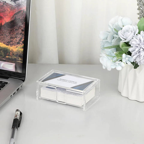 Clear Acrylic Business Card Holder With Display Lid on office desk next to flowers and laptop