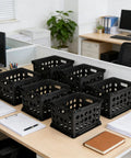 Durable Plastic File Crate With Ergonomic Handles For Letter And Legal Size Documents in black, shown on office desks, stackable design.