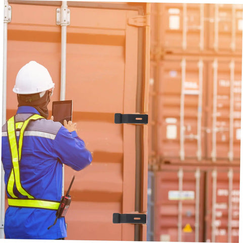 Worker inspecting Six Piece Flexible Draw Latch Kit with rubber lock latches on container, reduces vibration, concealed keeper.