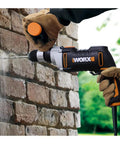 User drilling into brick wall with Knockout Impact Drill Packing 810 Watts And A Beefy 13 Mm Chuck Featuring Variable Speed Control.