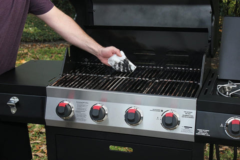 Person cleaning barbecue grill with Heavy Duty Surface And Hand Wipes 2 Pack 60 Count Pre Moistened Shop Wipes Tackle Paint Oil Grease Adhesives Mud And Dirt From Surfaces Tools And Gear.