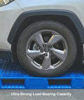 Heavy Duty Plastic Pallet With Breathable Grid Design, 40 X 32 X 6 Inch displayed supporting a car tire to show load capacity.